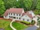 Aerial view of a well-manicured home with lush landscaping and a brick walkway at 400 Peachtree Pkwy, Peachtree City, GA 30269