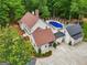 Aerial view of a beautiful home featuring a pool and lush greenery at 400 Peachtree Pkwy, Peachtree City, GA 30269