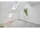 Bright attic features a window, skylight, neutral rug, and lots of natural light at 400 Peachtree Pkwy, Peachtree City, GA 30269