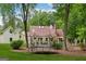 Expansive backyard with lush landscaping, featuring both a trampoline and in-ground pool at 400 Peachtree Pkwy, Peachtree City, GA 30269