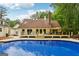 Stunning backyard with a large in-ground pool and multiple outdoor seating areas at 400 Peachtree Pkwy, Peachtree City, GA 30269