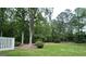 Spacious backyard with a trampoline, mature trees and white picket fence at 400 Peachtree Pkwy, Peachtree City, GA 30269