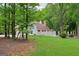 Lush backyard with mature trees, privacy fence, and well-kept lawn at 400 Peachtree Pkwy, Peachtree City, GA 30269
