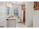 Stylish bathroom with granite countertop vanity, a wood-look tiled walk-in shower, and bright window at 400 Peachtree Pkwy, Peachtree City, GA 30269