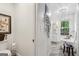 Bright bathroom featuring a standalone tub with a large window, modern fixtures, and a stylish chandelier at 400 Peachtree Pkwy, Peachtree City, GA 30269