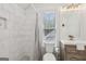 Modern bathroom featuring white tile, a shower with glass door, and a wood vanity at 400 Peachtree Pkwy, Peachtree City, GA 30269
