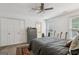 Bright bedroom features a ceiling fan, guitars, and neutral decor at 400 Peachtree Pkwy, Peachtree City, GA 30269