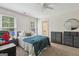 Bedroom with carpeted floors, ceiling fan, two windows, and dresser storage at 400 Peachtree Pkwy, Peachtree City, GA 30269