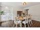 Bright dining room featuring a wooden table set for six, built-in cabinets, and contemporary lighting at 400 Peachtree Pkwy, Peachtree City, GA 30269