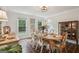 Inviting dining room featuring a wooden table set for six, with natural light from surrounding windows at 400 Peachtree Pkwy, Peachtree City, GA 30269