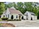 Beautiful home with a spacious driveway, complemented by lush greenery and a welcoming entrance at 400 Peachtree Pkwy, Peachtree City, GA 30269