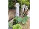 Landscaped front yard with flowers and painted brick fence creates a warm inviting atmosphere at 400 Peachtree Pkwy, Peachtree City, GA 30269