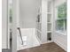 Bright hallway with wood floors, recessed lighting, a window, and built in white shelves at 400 Peachtree Pkwy, Peachtree City, GA 30269
