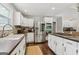 Well-equipped kitchen featuring white cabinets, stainless steel appliances, and tile floors at 400 Peachtree Pkwy, Peachtree City, GA 30269