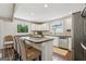 Bright kitchen features white cabinets, stainless steel appliances, and a central island with bar seating at 400 Peachtree Pkwy, Peachtree City, GA 30269