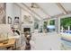 Bright living room with vaulted ceilings, exposed beams, fireplace, and views of the deck and backyard at 400 Peachtree Pkwy, Peachtree City, GA 30269