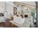 Bright living room with vaulted ceilings, exposed beams, fireplace, and white sofas at 400 Peachtree Pkwy, Peachtree City, GA 30269