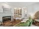 Bright living room features a fireplace, built-in bookshelves and comfortable seating arrangement at 400 Peachtree Pkwy, Peachtree City, GA 30269