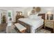 Inviting bedroom with neutral tones, decorative wall accents and a glimpse of a luxurious ensuite bathroom at 400 Peachtree Pkwy, Peachtree City, GA 30269