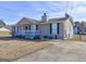 Single story home with front porch, green trim and drought resistant lawn at 70 Grove Creek Dr, Locust Grove, GA 30248