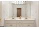 Bathroom featuring double sinks in a white vanity with modern fixtures at 891 Berryman Pl, Lawrenceville, GA 30045