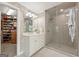 Bright bathroom with a glass shower, vanity, and access to a walk-in closet at 891 Berryman Pl, Lawrenceville, GA 30045