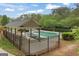 Community pool enclosed by a fence and a covered picnic area at 891 Berryman Pl, Lawrenceville, GA 30045