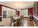 Formal dining room with hardwood floors, large windows, and stylish decor at 891 Berryman Pl, Lawrenceville, GA 30045