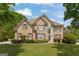 Charming brick two-story home with manicured lawn and mature trees, perfect for suburban living at 891 Berryman Pl, Lawrenceville, GA 30045