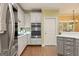 Well-equipped kitchen with stainless steel appliances, stylish backsplash and white cabinets at 891 Berryman Pl, Lawrenceville, GA 30045