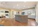 Bright eat-in kitchen featuring hardwood floors and a view into the living room at 891 Berryman Pl, Lawrenceville, GA 30045