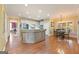Open-concept kitchen with island, stainless steel appliances, and hardwood floors at 891 Berryman Pl, Lawrenceville, GA 30045
