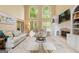 Bright living room with two-story windows, fireplace, and neutral decor at 891 Berryman Pl, Lawrenceville, GA 30045