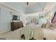 Airy main bedroom with a tray ceiling, cozy carpet, and soft, natural light from the sunroom/office nook at 891 Berryman Pl, Lawrenceville, GA 30045