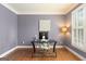 Home office with hardwood floors, shutters, and a modern desk setup at 891 Berryman Pl, Lawrenceville, GA 30045
