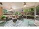 Cozy screened porch with comfortable seating, ceiling fans, and views of the lush backyard and greenery at 891 Berryman Pl, Lawrenceville, GA 30045