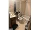 Bathroom featuring a shower and tub combo, a toilet with an open lid, and single sink vanity at 1975 Longwood Ct, Lithonia, GA 30058