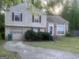 Charming split-level home featuring a brick facade, garage, and well-maintained front yard at 1975 Longwood Ct, Lithonia, GA 30058