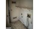 Laundry room featuring unfinished repairs, exposed outlets, and a wire shelf at 1975 Longwood Ct, Lithonia, GA 30058