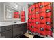 Bathroom with dark wood vanity, framed mirror, and shower with Georgia Bulldog themed curtain at 240 Sturry Dr # 71, Mcdonough, GA 30252
