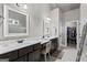 Bathroom featuring dual sinks with dark wood cabinetry, a large mirror and a walk-in closet at 240 Sturry Dr # 71, Mcdonough, GA 30252