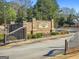 A stately brick entrance welcomes visitors to Canterbury Hills with manicured landscaping surrounding the signage at 240 Sturry Dr # 71, Mcdonough, GA 30252