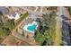 An aerial view of the community pool surrounded by manicured landscaping, parking and a clubhouse at 240 Sturry Dr # 71, Mcdonough, GA 30252