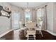 Cozy breakfast nook with natural light, hardwood floors, and designer window treatments at 240 Sturry Dr # 71, Mcdonough, GA 30252