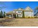 Charming home featuring a covered front porch, manicured lawn, and traditional architectural design, complete with detailed shutters at 240 Sturry Dr # 71, Mcdonough, GA 30252