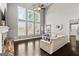 Bright living room with soaring ceilings, large windows, fireplace, and elegant hardwood flooring at 240 Sturry Dr # 71, Mcdonough, GA 30252