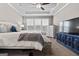 This main bedroom features a tray ceiling, a ceiling fan and natural light streaming in through the window at 240 Sturry Dr # 71, Mcdonough, GA 30252