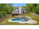 Aerial shot of the backyard with pool, spa, patio and house at 608 Bellenden Dr, Peachtree City, GA 30269