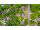 Aerial view of a home with mature trees, in-ground pool, driveway, and surrounding neighborhood at 608 Bellenden Dr, Peachtree City, GA 30269