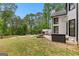 Expansive backyard featuring a custom fire pit area, a grassy lawn, and mature trees for privacy at 608 Bellenden Dr, Peachtree City, GA 30269